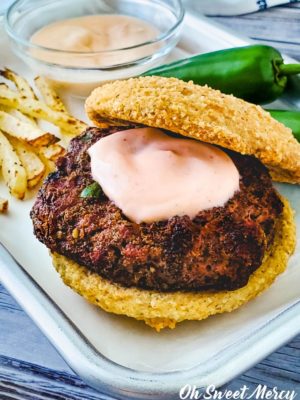 Close up of jalapeno burger with sriracha burger sauce on patty