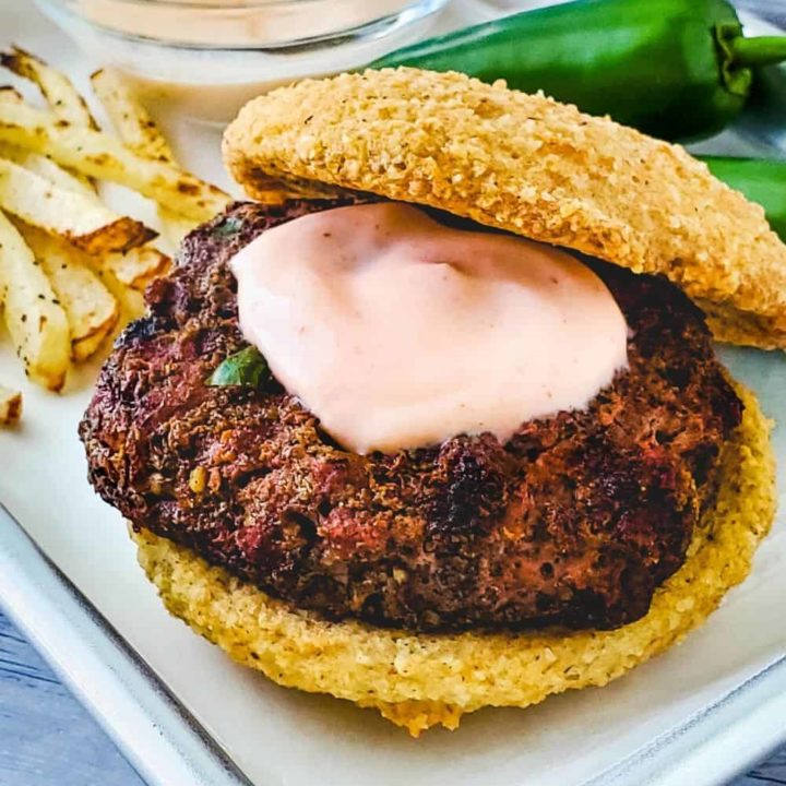 Close up of jalapeno burger with sriracha burger sauce on patty