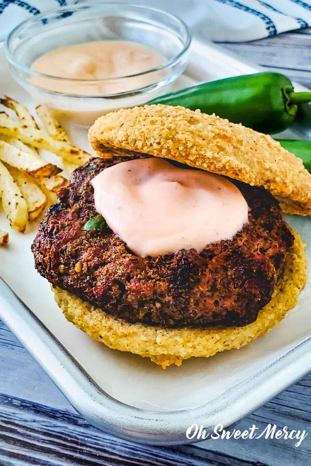 Close up of jalapeno burger with sriracha burger sauce on patty