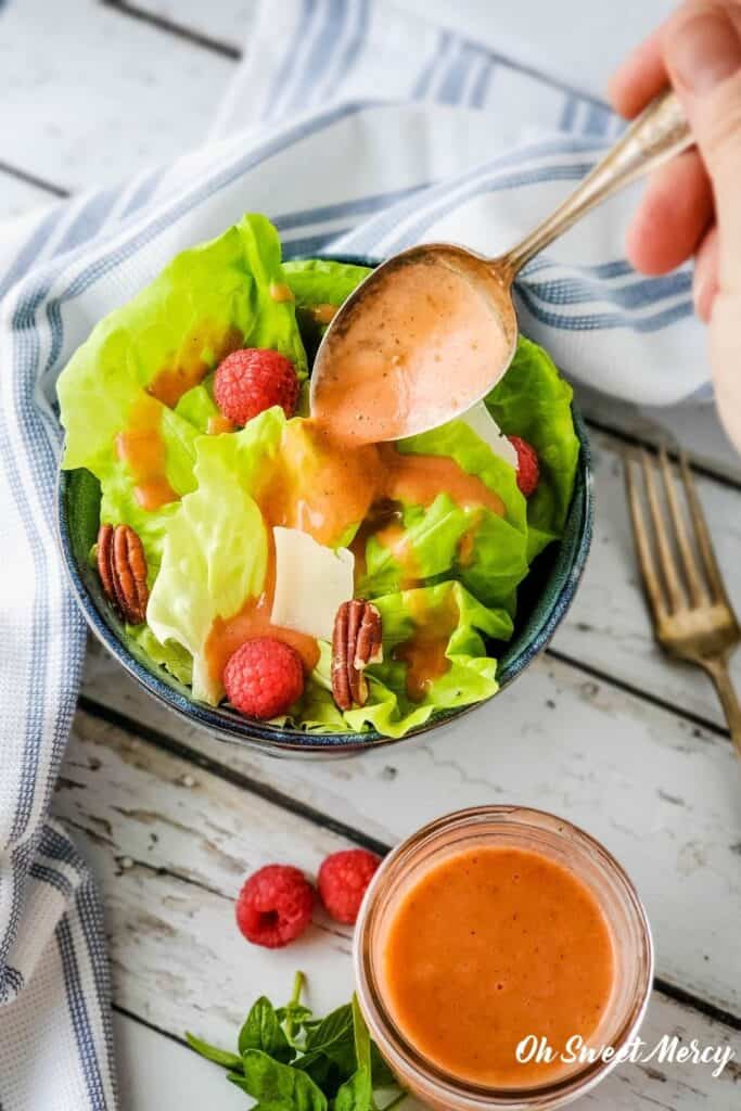 Pouring dressing over salad