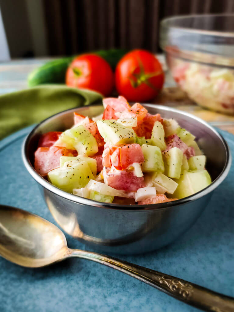 Close up photo of Creamy Cucumber Tomato Salad in a bowl.