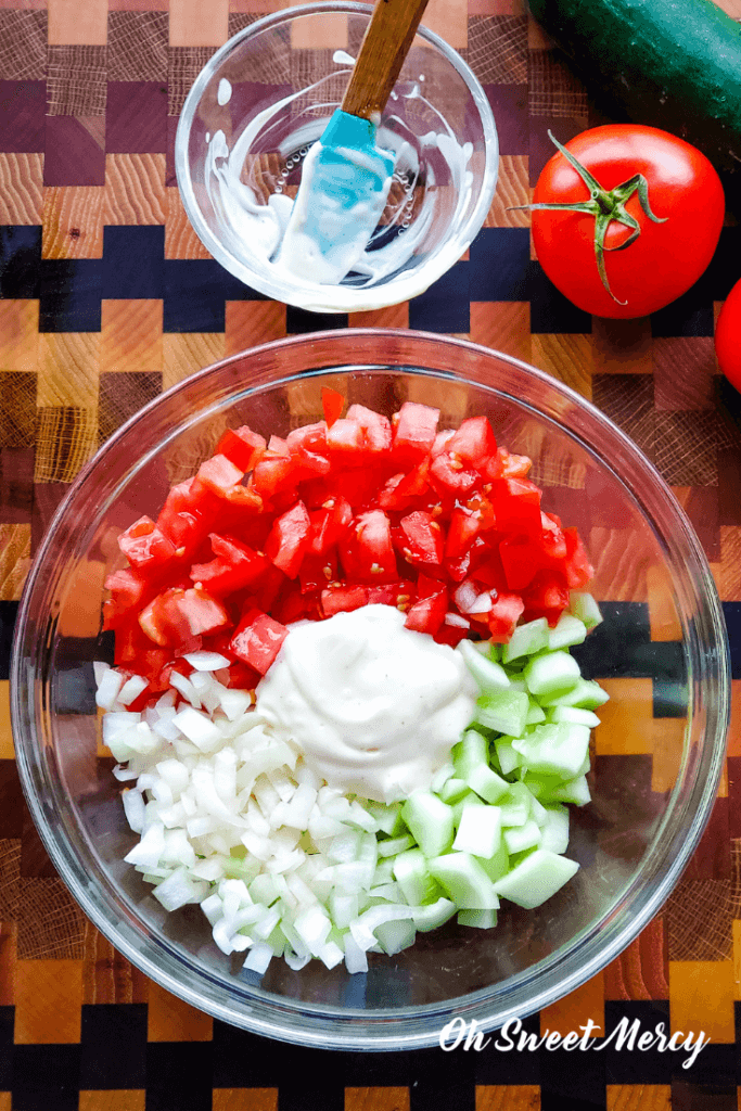 Creamy Cucumber Tomato Salad ingredients in a bowl