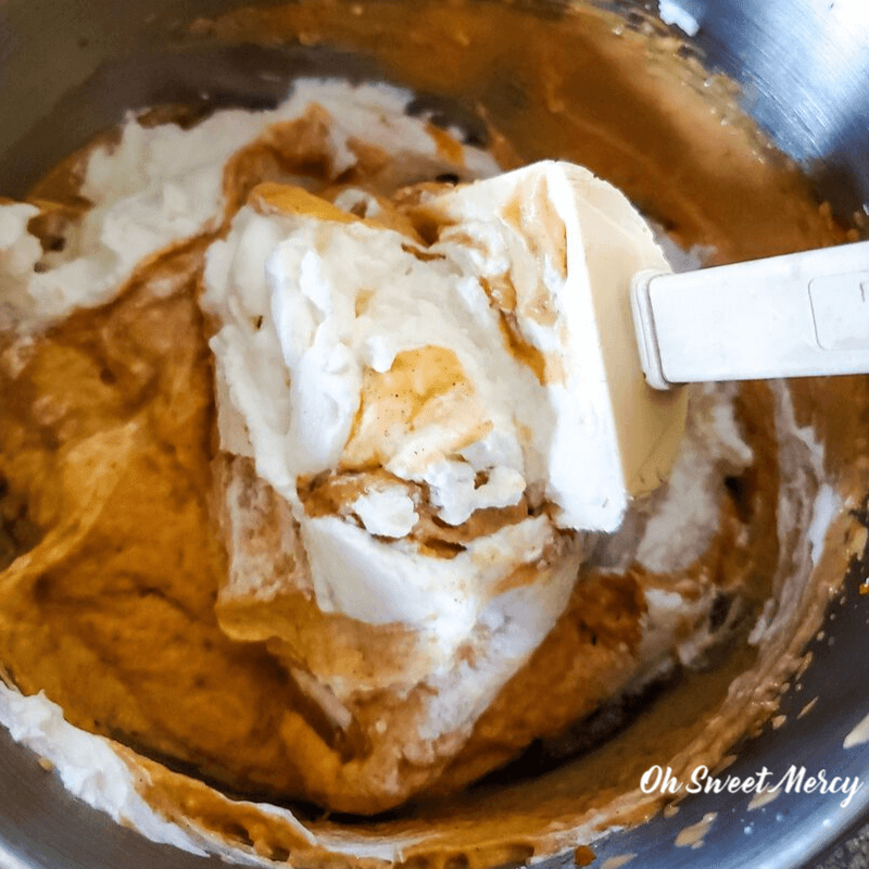 folding whipped cream into pumpkin mixture