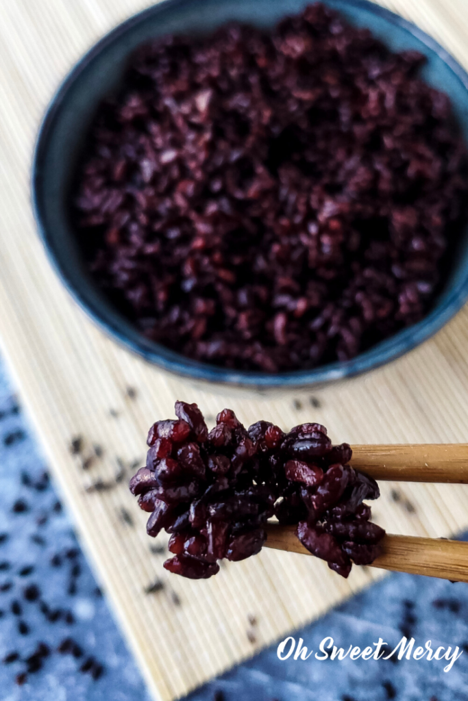 Black rice on chopsticks