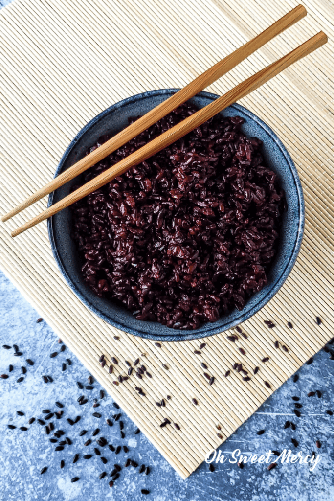 bowl of black rice with chopsticks