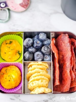 Breakfast on the go snack box - egg puffs, blueberries, cheese crisps, cooked turkey bacon.