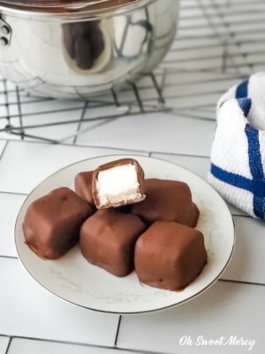 Chocolate covered cheesecake bites on a plate