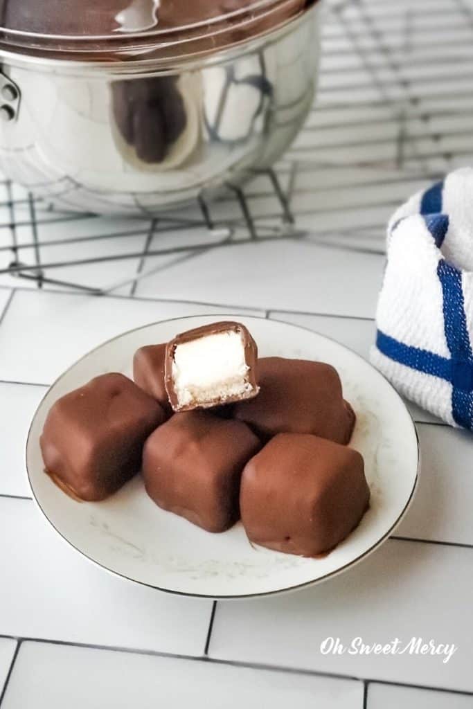 Chocolate covered cheesecake bites on a plate