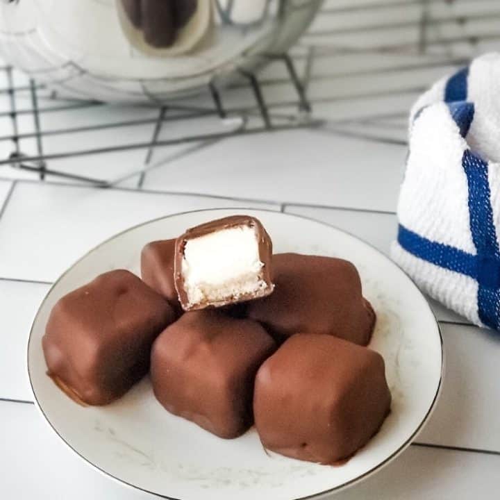 Chocolate covered cheesecake bites on a plate
