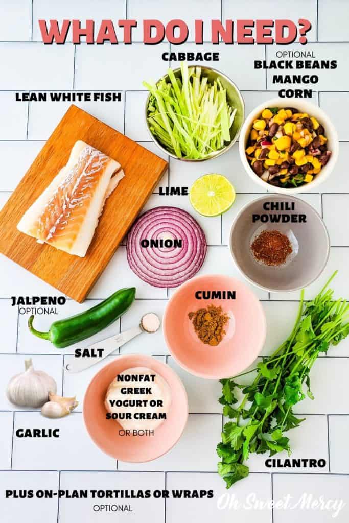 Fish tacos ingredients: skinless, lean, white fish, shredded cabbage, onion, lime, garlic, salt, cumin, chili powder, nonfat Greek yogurt or sour cream, jalapeno, black beans, corn, mango, cilantro, tortillas.