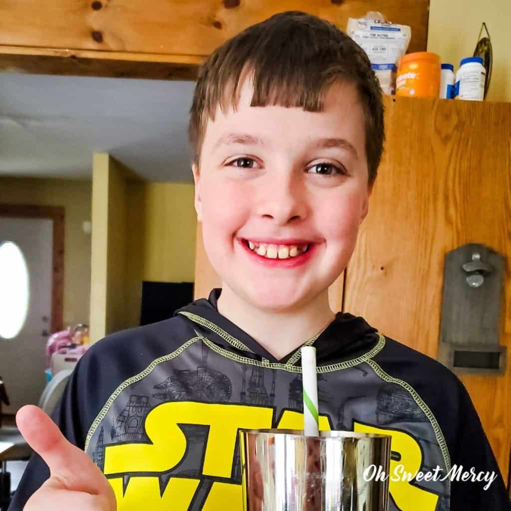 My son giving me thumbs up after tasting peanut butter and jelly smoothie