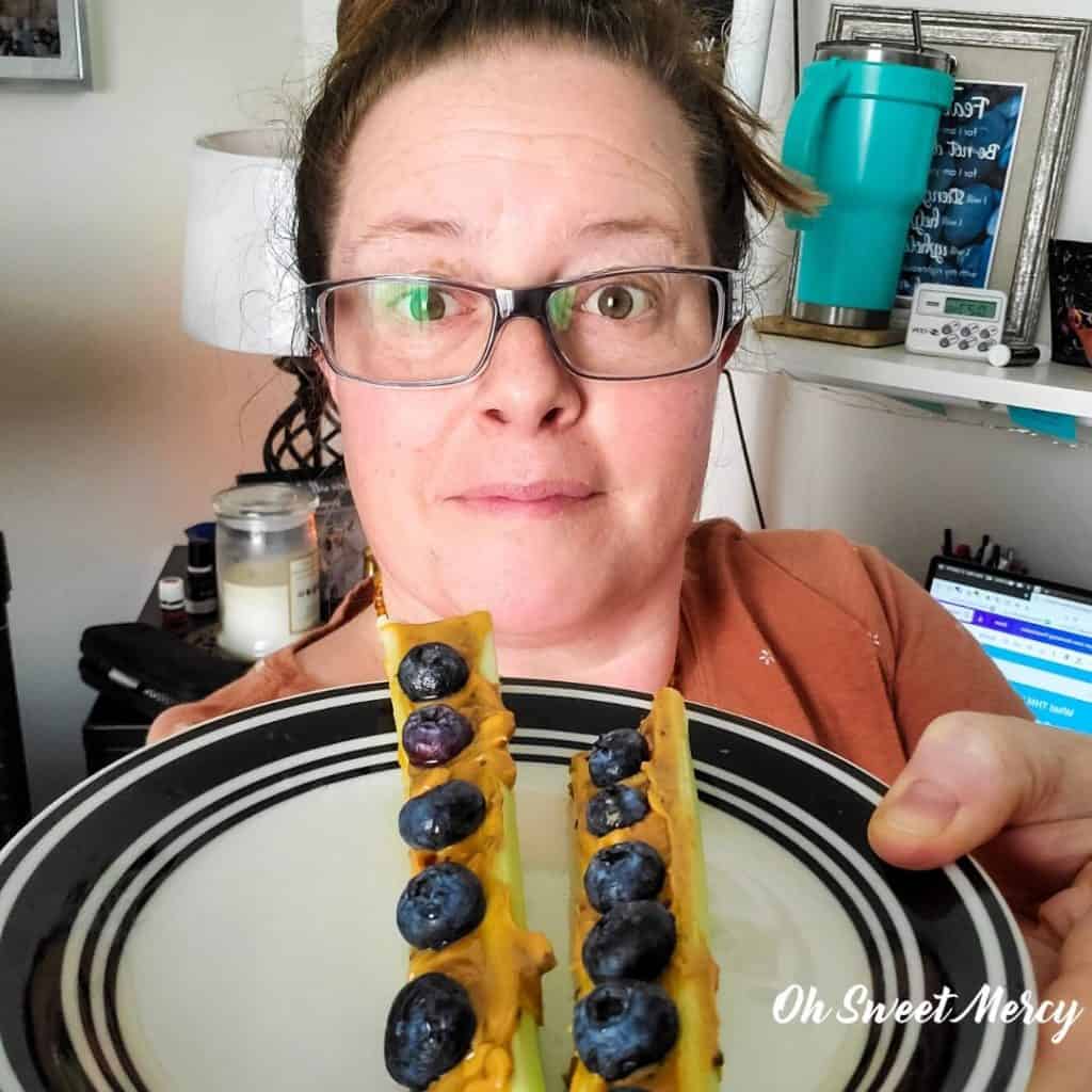 Me with a plate of ants on a log using peanut butter with flax and chia spread