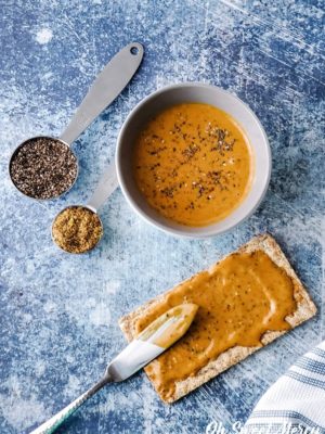 Bowl of peanut butter flax and chia seeds with a cracker