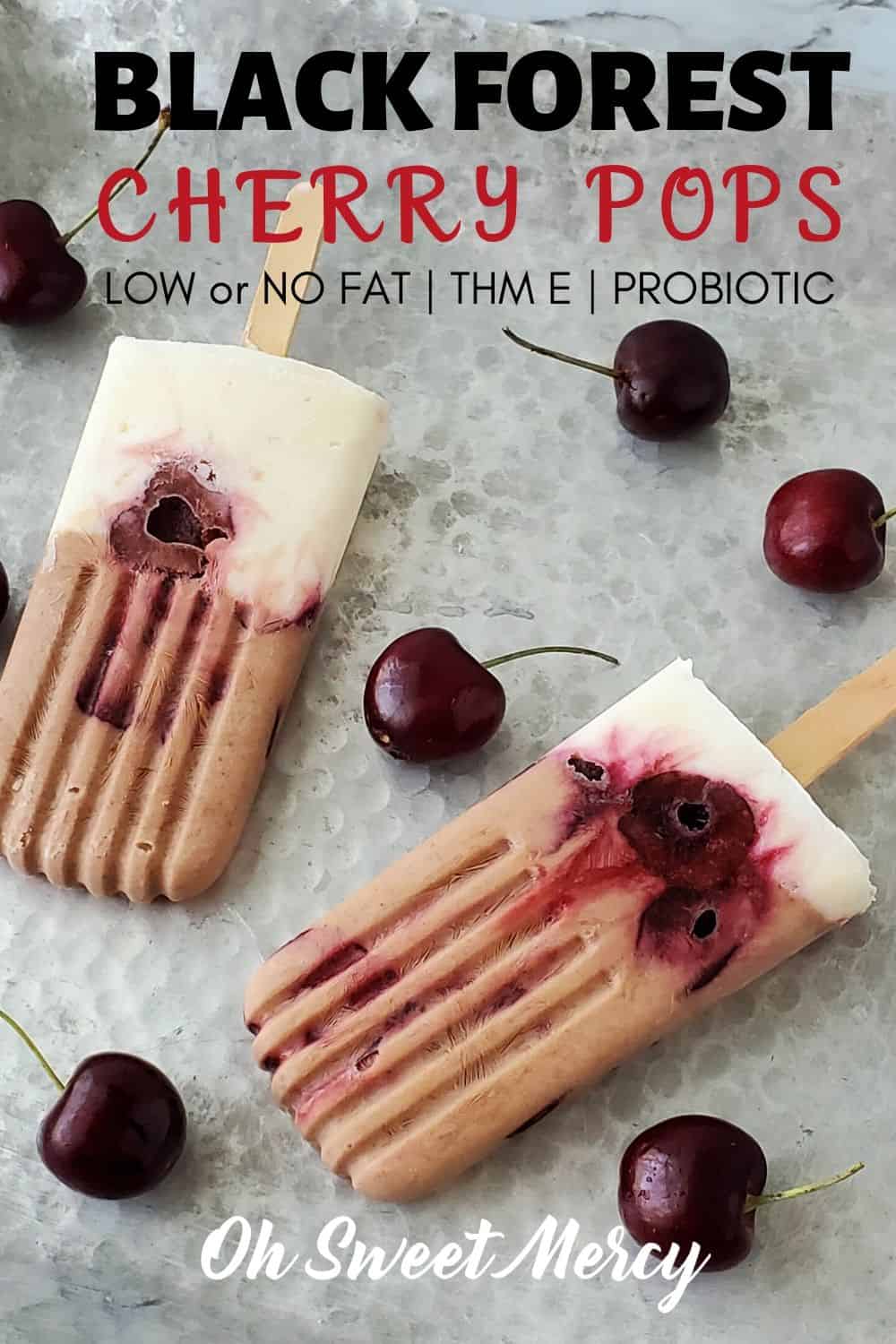 Love the flavors of Black Forest Cherry desserts but don't want all the fat and calories? My layered, low (or no) fat Black Forest Cherry pops layer creamy, chocolate Greek yogurt, dark sweet cherries, and vanilla yogurt for a healthy and delicious THM E dessert or snack. #lowfat #thm #healthycarbs #blackforestcherry #thmsnacks #thmdesserts #cacao #probiotic #yogurtpops @ohsweetmercy