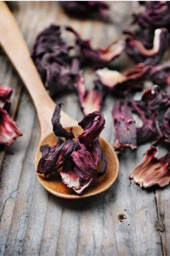 Hibiscus flowers on wooden spoon