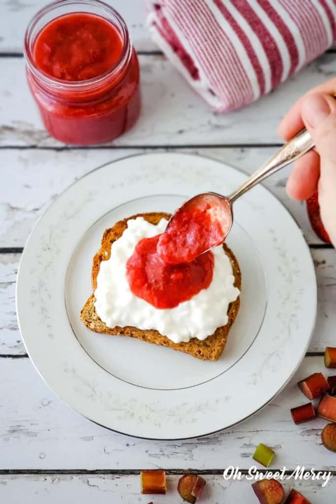 Spooning sugar free strawberry rhubarb sauce over cottage cheese on toast