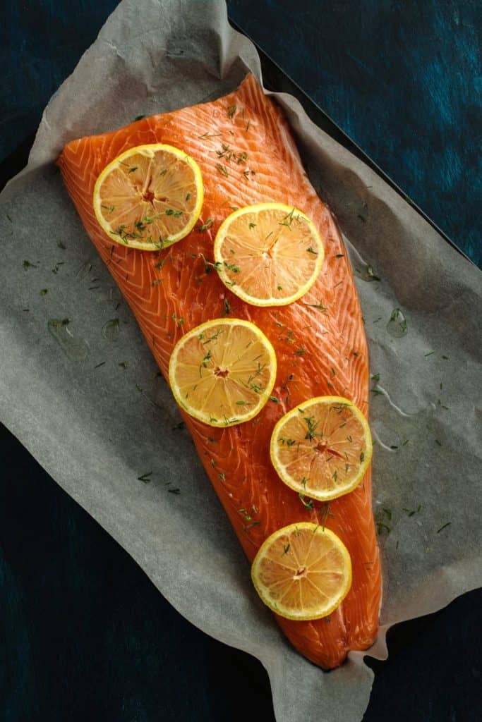 Salmon and lemon slices on baking sheet. Canva pro image