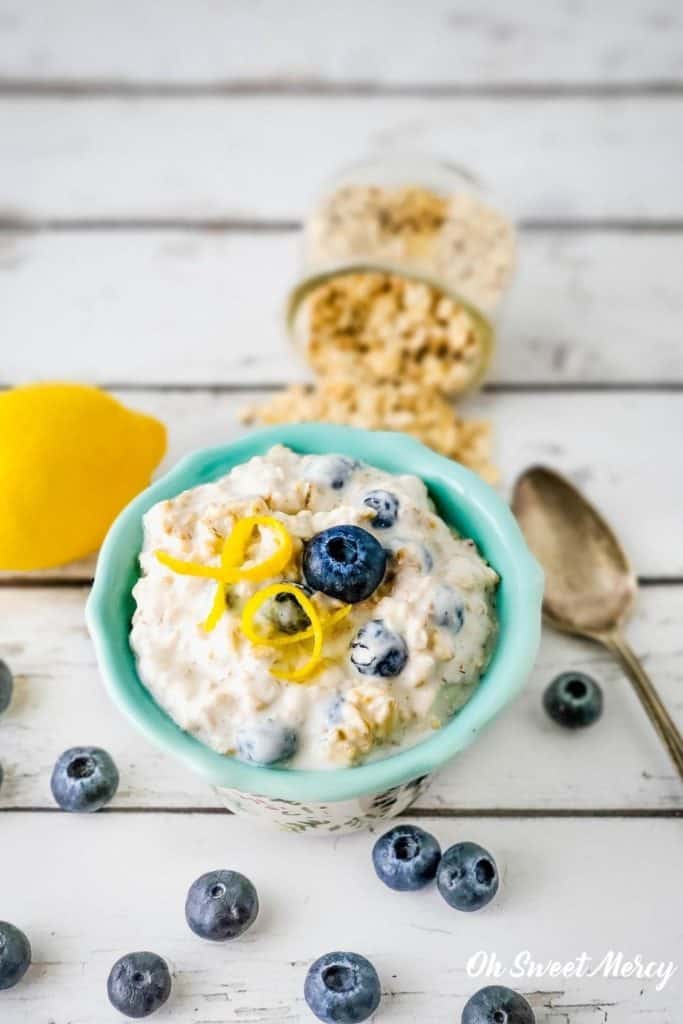 Bowl of overnight oats garnished with blueberry and lemon zest.