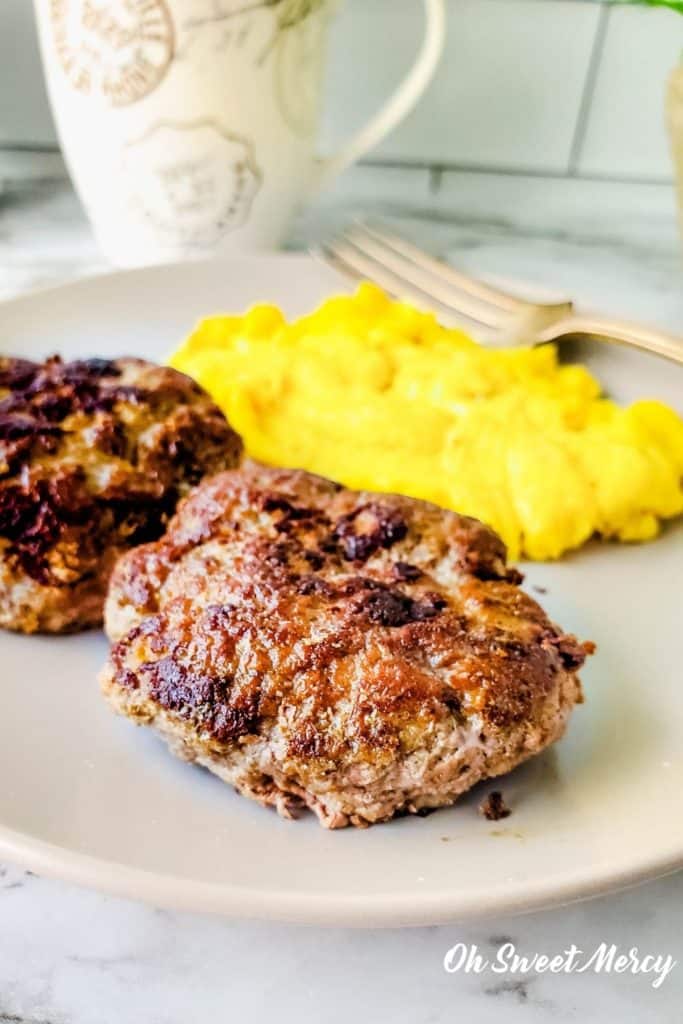 Close up of sugar free breakfast sausage patties with scrambled eggs