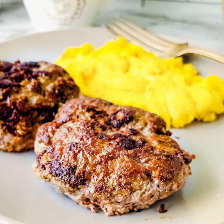 Close up of sugar free breakfast sausage patties with scrambled eggs