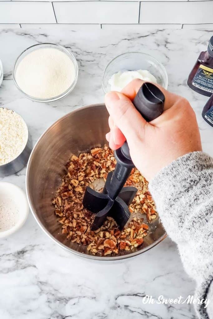 Using a Pampered Chef Mix 'n Chop to chop pecans into small pieces