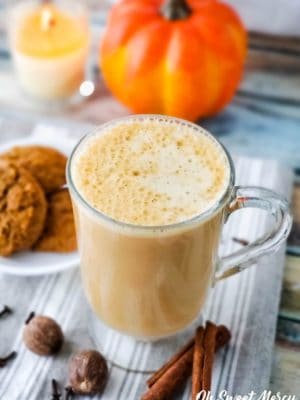 Beverage in clear glass mug with plate of cookies