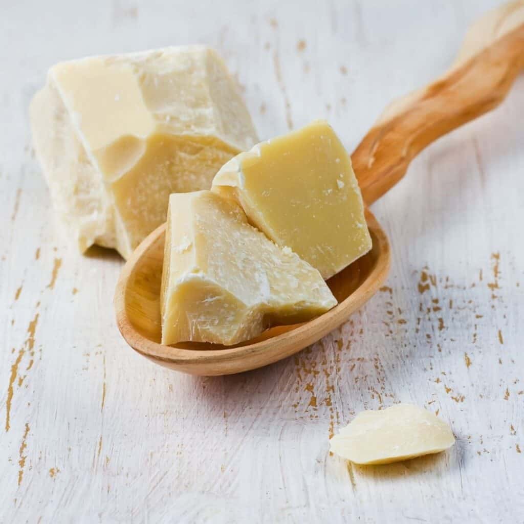 Cacao butter chunks on a spoon