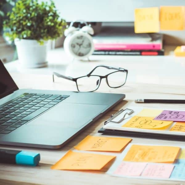 laptop and sticky notes on a desk