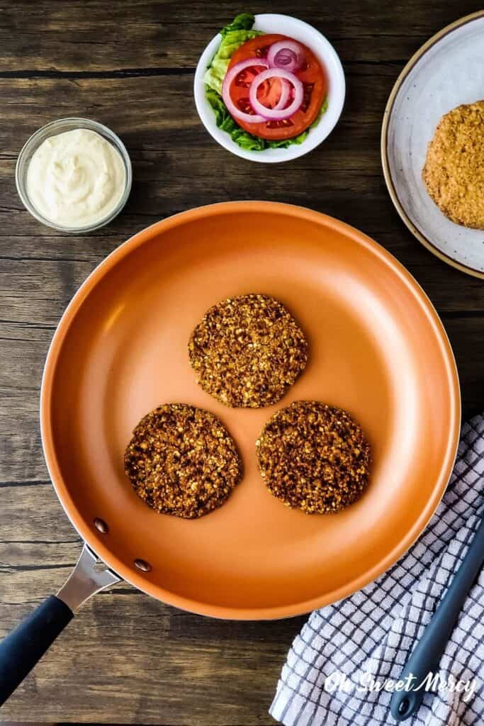 overhead shot of lentil patties in copper ceramic skillet