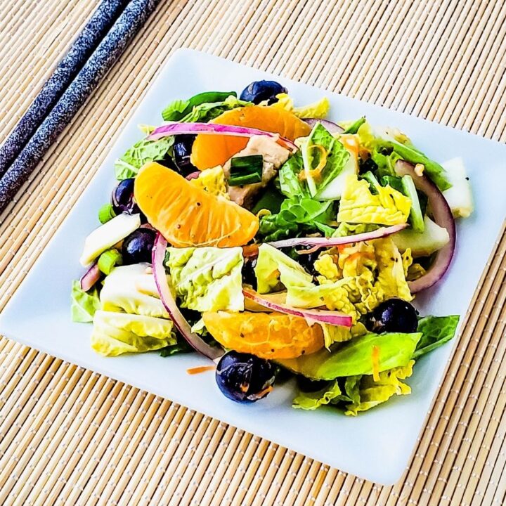 square white plate with mandarin blueberry napa cabbage salad