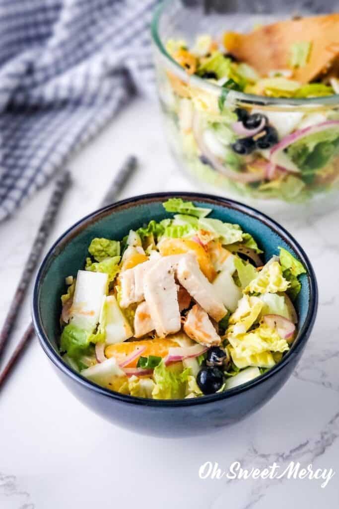 Close up of bowl of salad with chicken.