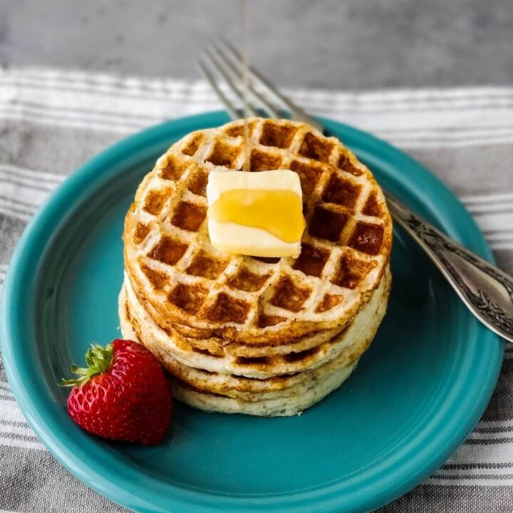 Pouring syrup on a stack of mini waffles