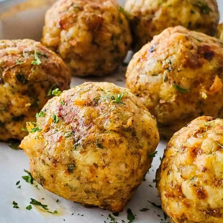 Close up of cooked turkey meatballs on baking sheet