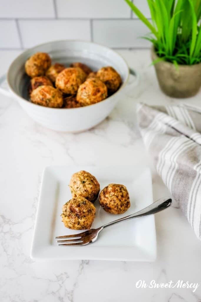 Meatballs on white square plate with fork