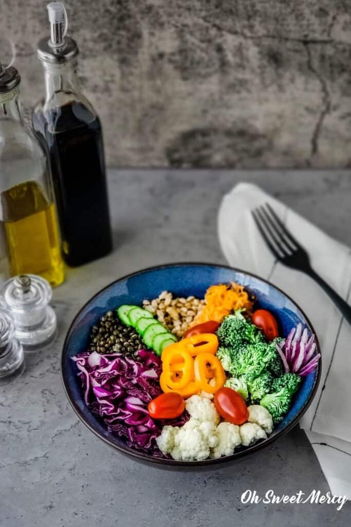 Grain bowl with oil and vinegar bottles