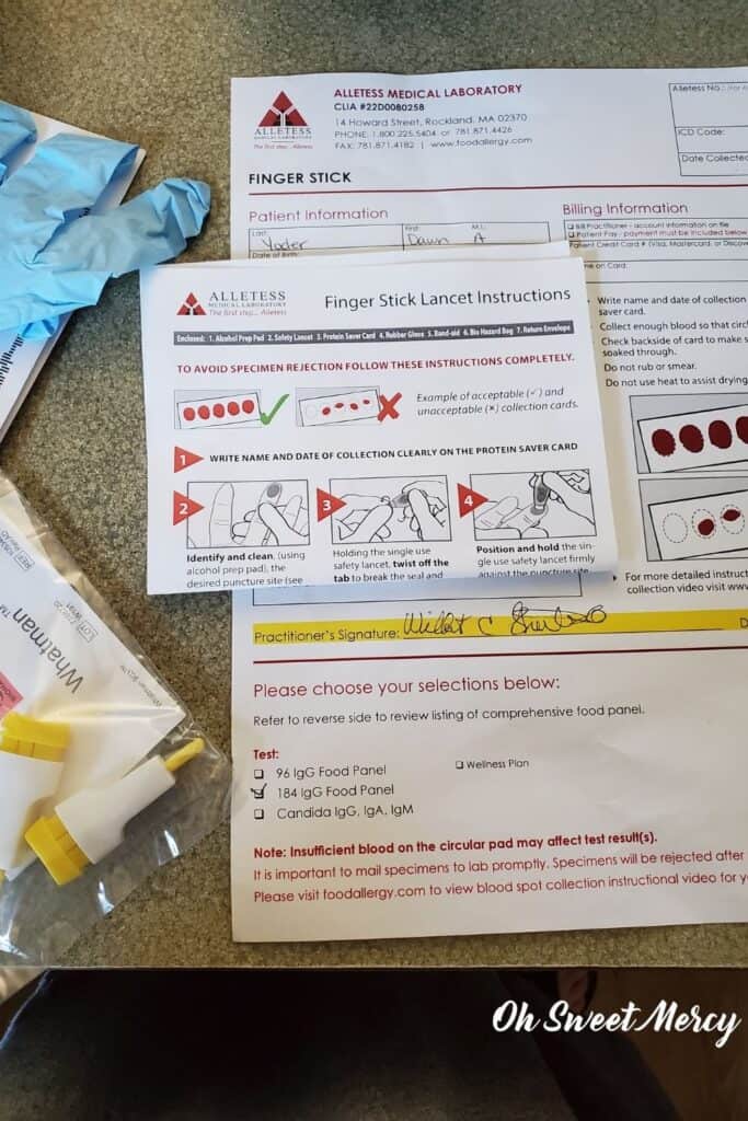 Photo of contents of the at-home food sensitivity test I got from my naturopath: lancets, glove, instructions showing how to collect samples.