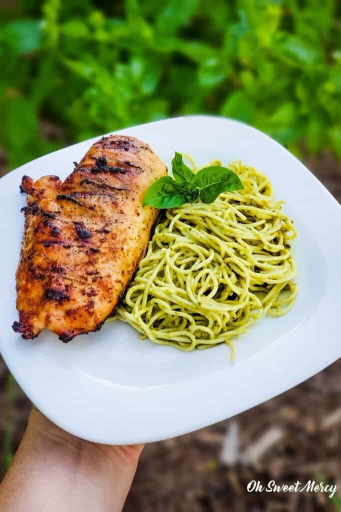 Plate of grilled chicken and pesto pasta made with Barilla Creamy Genovese Pesto.