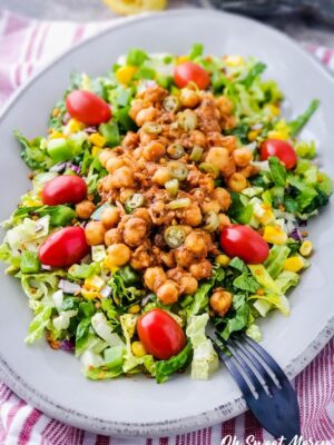 Plate of Chickpea Taco Salad on a red and white striped background.