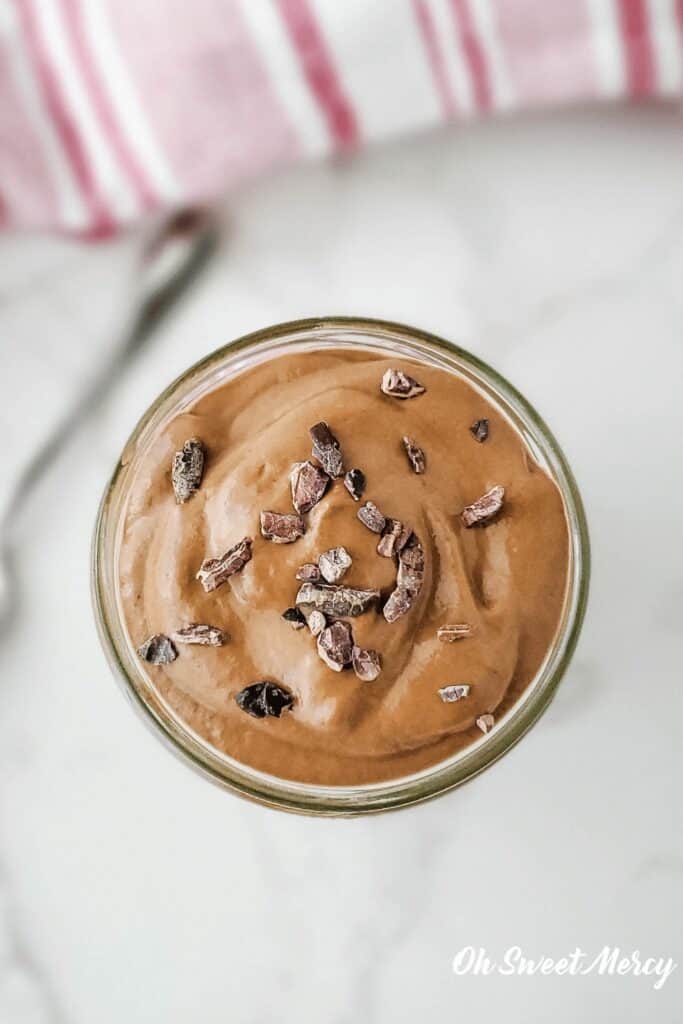 Overhead shot of Dairy Free Chocolate Protein Pudding with raw cacao nibs sprinkled on top