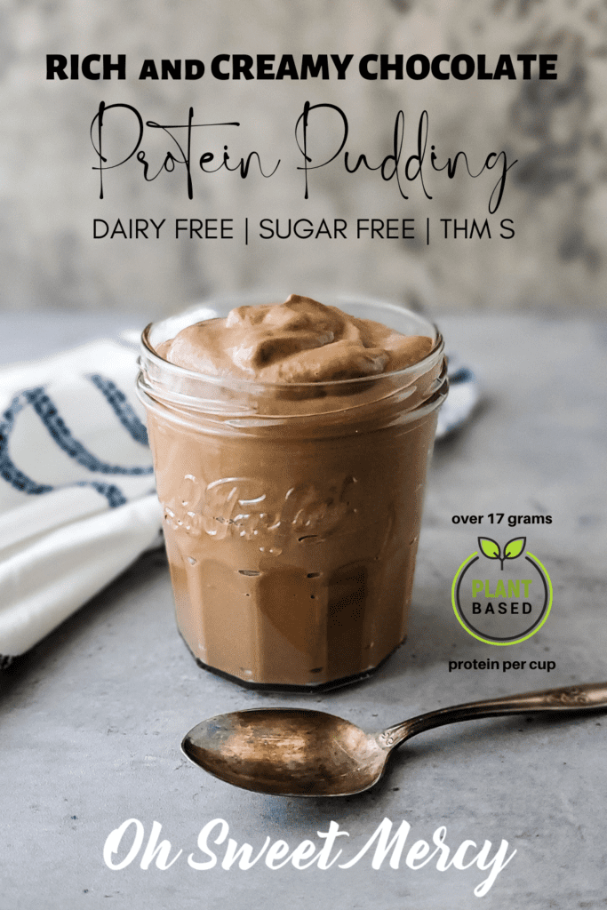 Pinterest Pin Image: Glass jar of pudding with a spoon in front of it. Text: Rich and Creamy Chocolate Protein Pudding Dairy Free Sugar Free THM S over 17 grams plant based protein per cup