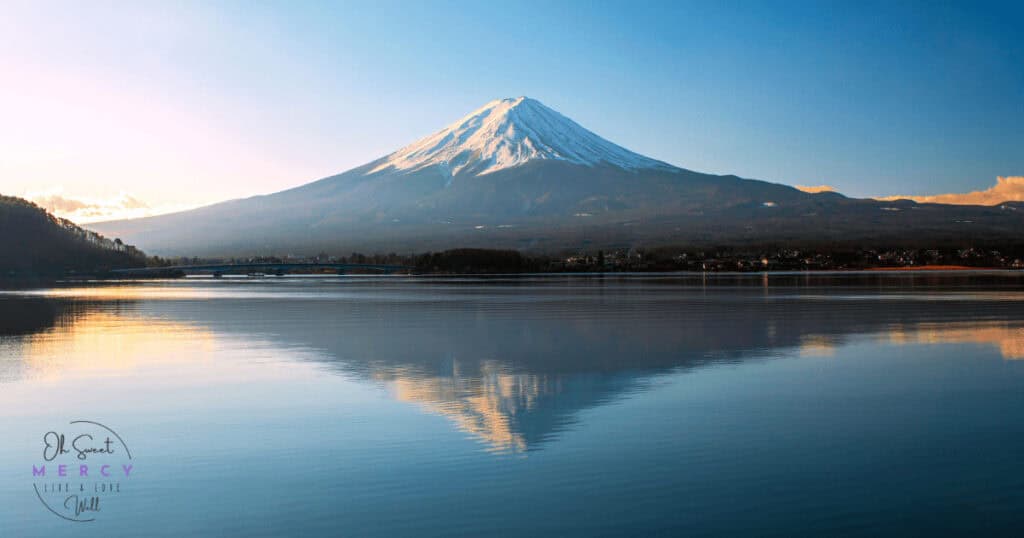 Snow capped mountain reflecting in water